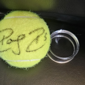 ROGER FEDERER signed US Open tennis ball. Free plastic tennis ball holder included.