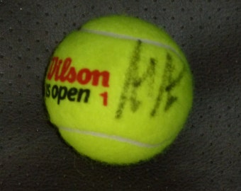 ANDRE AGASSI autographed US Open tennis ball with Certificate of Authenticity plus free handmade plastic ball stand.