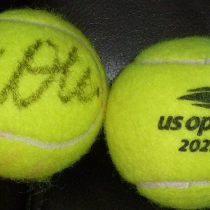 COCO GAUFF  Autographed , used and dated  2023 US Open tennis  ball plus free handmade plastic ball stand.