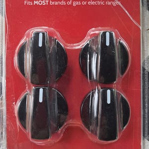 May include: Package of Smart Choice Universal Range Knobs. The package includes four black knobs with white indicator lines and a variety of colored adapters. The packaging is red with white text.