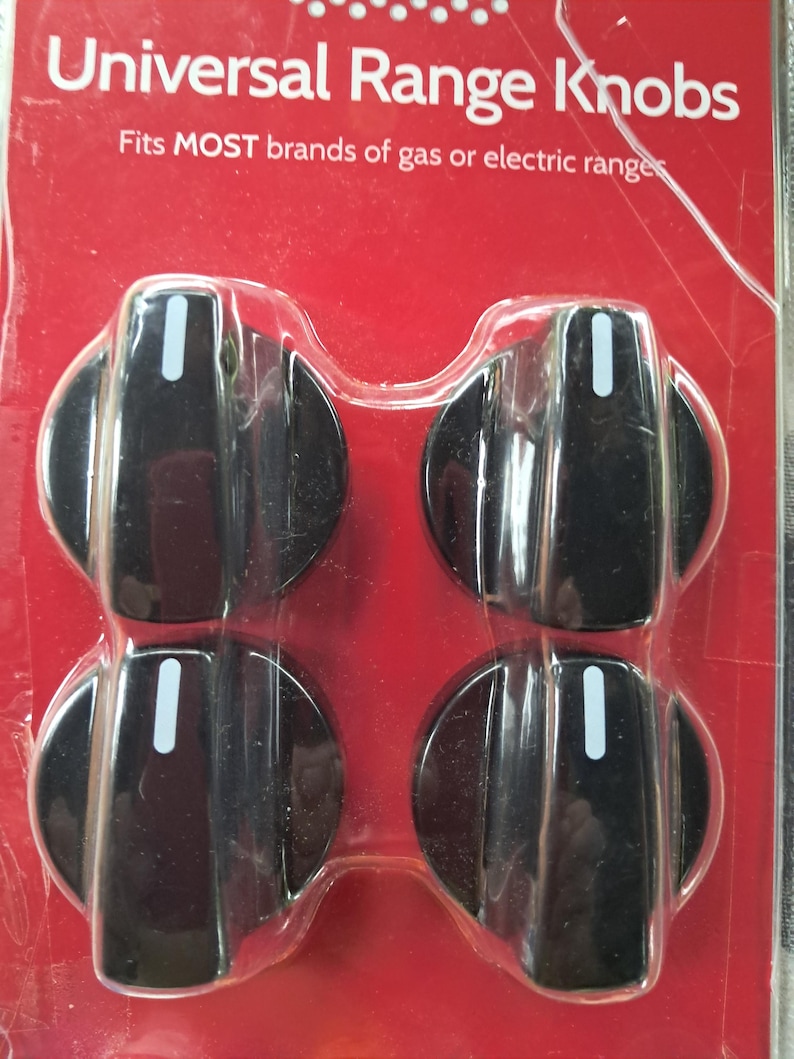 May include: Four black universal range knobs in a clear plastic package. Each knob has a white indicator line. The packaging is red with white text that reads "Universal Range Knobs" and "Fits MOST brands of gas or electric ranges."