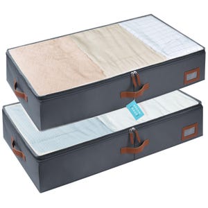May include: Two gray storage containers with clear tops, filled with folded linens. Each container has brown leather handles and a zipper closure. A tag that says "ORGANIC HAUS" hangs from one of the zippers.