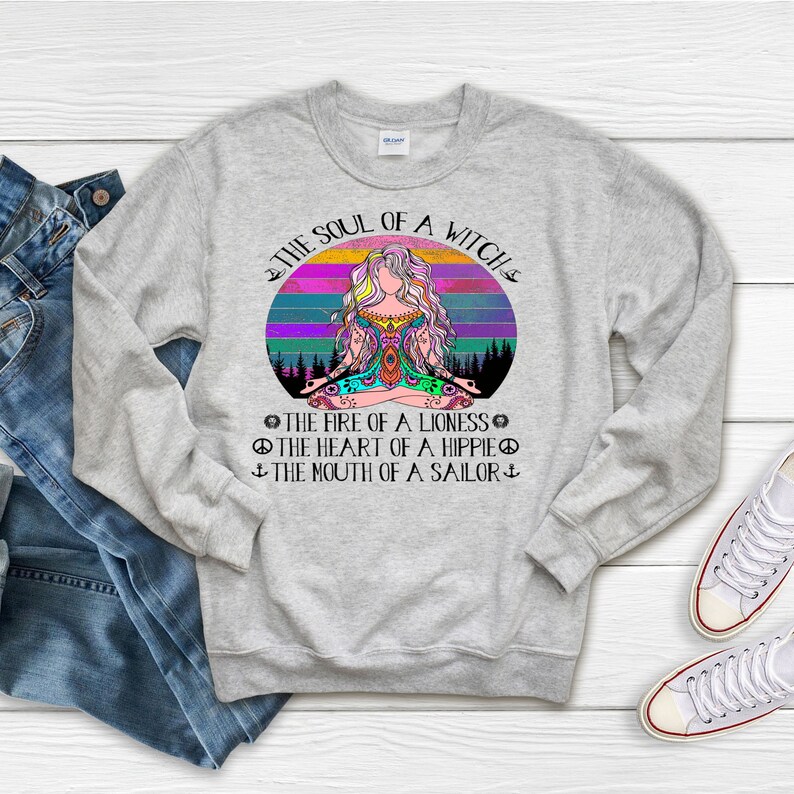 May include: Gray sweatshirt with a colorful graphic of a woman meditating with a sunset background. The text reads "The Soul of a Witch, The Fire of a Lioness, The Heart of a Hippie, The Mouth of a Sailor."