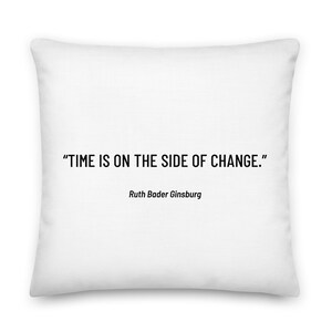 May include: White throw pillow with the quote "TIME IS ON THE SIDE OF CHANGE." by Ruth Bader Ginsburg.