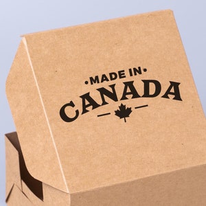 May include: A brown cardboard box with the text "MADE IN CANADA" printed on the top. A small maple leaf is printed below the text.