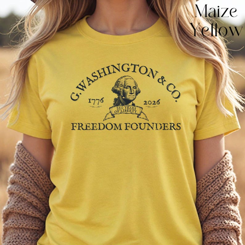 May include: Maize yellow t-shirt featuring the text "G. Washington & Co." with the years 1776 and 2026. The shirt also includes an image of George Washington and the words "Freedom Founders".