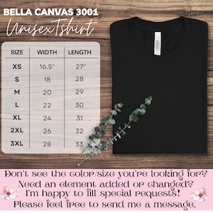 May include: A black unisex t-shirt with a size chart and the text "BELLA CANVAS 3001 Unisex Tshirt". The size chart shows measurements in inches. The shirt is folded and displayed on a wooden surface.