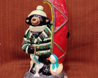 Camping black bear with canoe ceramic figurine