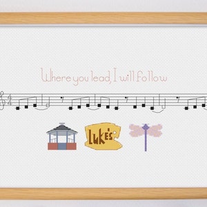 May include: A framed cross-stitch design featuring a musical staff with notes, a gazebo, a sign that says "Luke's", and a dragonfly. The text "Where you lead, I will follow" is written above the musical staff.