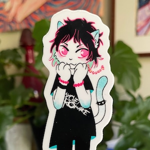 May include: A sticker of a cartoon cat with pink hair, wearing a black shirt with the text "YCHE ROMANCE" in white. The cat is wearing a blue bracelet and a pink necklace with a heart charm. The cat has blue eyes and a white tail with a black studded collar.