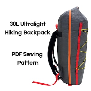 May include: A 30L ultralight hiking backpack PDF sewing pattern. The dark gray backpack features a vertical orange zipper, red webbing loops, and yellow bungee cord lacing on the side. The text 30L Ultralight Hiking Backpack PDF Sewing Pattern is visible.
