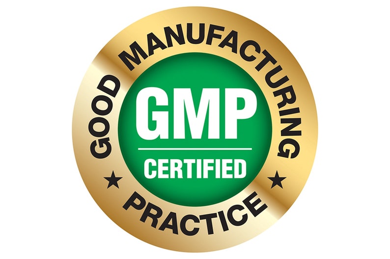 May include: A gold-colored circular emblem with the words "GOOD MANUFACTURING PRACTICE" in black around the outer edge. The center features a green circle with the letters "GMP" in white and the word "CERTIFIED" below. Two black stars are on the emblem.