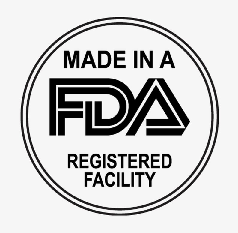 May include: A circular black and white graphic with the text "MADE IN A FDA REGISTERED FACILITY". The FDA logo is in the center, with a double-lined border around the text.