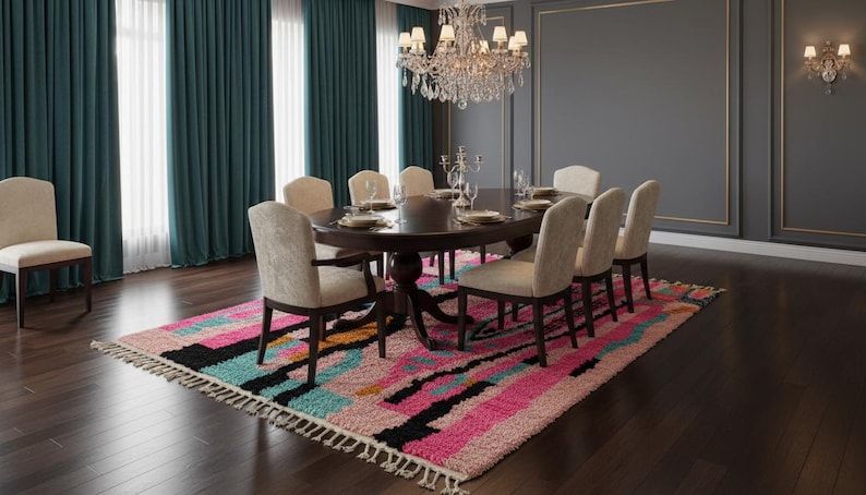 May include: A formal dining room with a large oval table set for a meal. Eight upholstered chairs surround the table, which is set on a colorful rug. Teal curtains and a crystal chandelier complete the elegant setting.