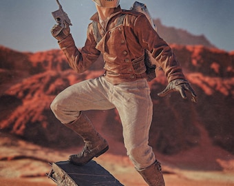 May include: A person in a brown leather jacket, light gray pants, and brown boots, holding a gun. They wear a metallic helmet with eye holes and a backpack. The background features a reddish landscape under a blue sky.