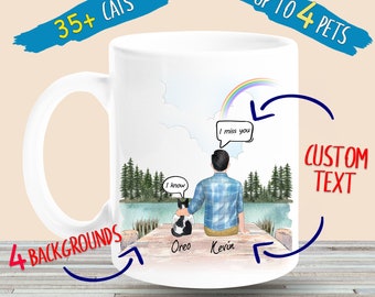 May include: White ceramic coffee mug with a watercolor illustration of a person and a cat sitting on a dock. The background features a lake, trees, and a rainbow. The text "I know" and "I miss you" are in speech bubbles. The names "Oreo" and "Kevin" are written below the cat and person.