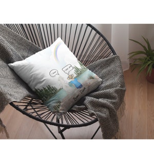 May include: White throw pillow with a watercolor illustration of a girl standing by a lake with a rainbow in the sky. The girl is looking at a white figure with the words "I know" and "I miss you" in speech bubbles. The text "Bronx. Dive" is written at the bottom of the pillow.