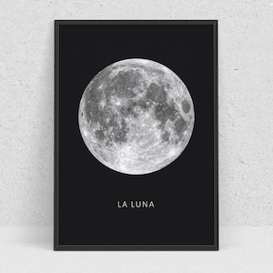 May include: A black and white print of a full moon with the text "LA LUNA" below it.