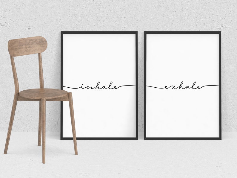 May include: Two black framed prints with white backgrounds and black cursive text. The left print says "inhale" and the right print says "exhale".