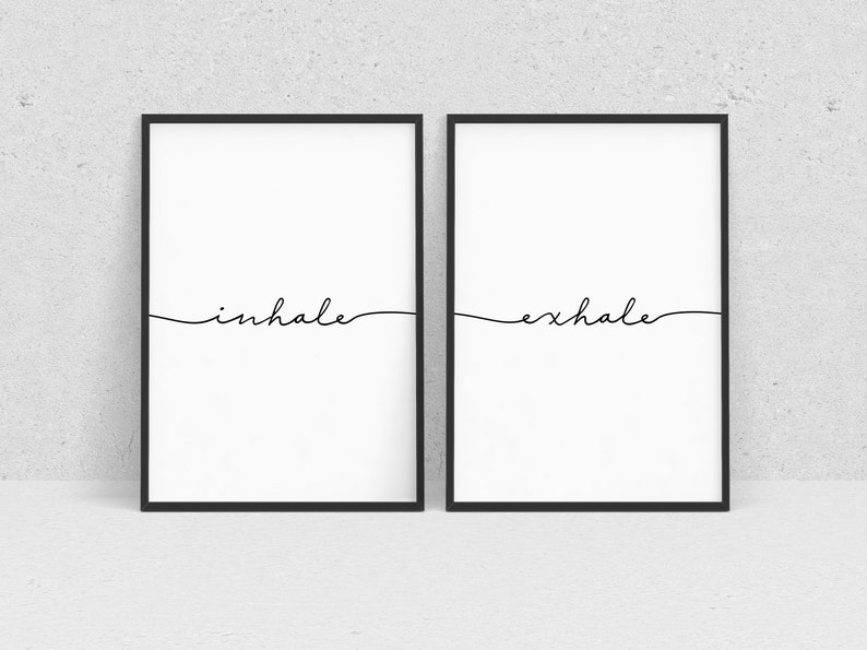 May include: Two black framed prints with white backgrounds. The left print has the word "inhale" written in cursive. The right print has the word "exhale" written in cursive.