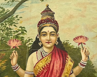 May include: A colorful illustration of the Hindu goddess Lakshmi standing on a pink lotus flower. She is adorned with jewelry and flowers, and is holding two lotus flowers in her hands. A white elephant with a garland of flowers is in the water behind her.