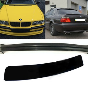 May include: A black rear bumper spoiler for a BMW 7 Series E38. The spoiler is made of a durable material and has a sleek, aerodynamic design.