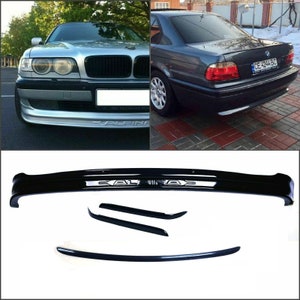 Könnte beinhalten: Ein schwarzer Kunststoff-Stoßfänger mit dem eingeprägten Wort "ALPINA". Der Stoßfänger ist für einen BMW 7er E38 konzipiert. Das Bild zeigt auch einen silbernen BMW 7er E38 und einen grauen BMW 7er E38.