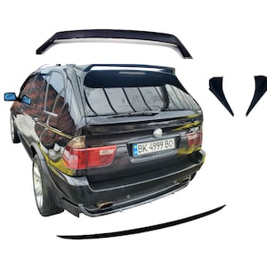 May include: Black BMW X5 SUV with a rear spoiler, side skirts, and a roof spoiler. The car has a license plate that reads "BK 4999 BO".