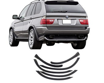 May include: A set of black plastic wheel arch trim pieces for a silver BMW X5 SUV. The trim pieces are designed to protect the wheel arches from damage and add a sporty look to the vehicle.