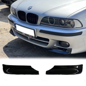May include: A pair of black gloss finish car bumper lip spoilers. The spoilers are designed to fit a BMW 5 Series E39.