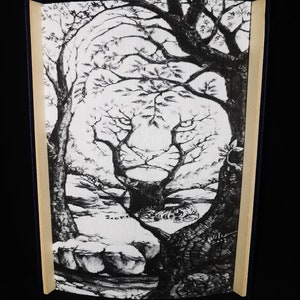 May include: Black and white drawing of a lion's face hidden within the branches of a tree. The drawing is framed in a black and wood frame.