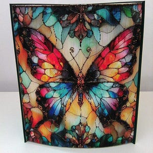 May include: A colorful butterfly with stained glass wings, set against a background of smaller butterflies. The butterfly is made of glass and has a metallic finish.