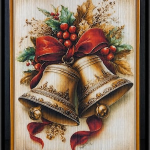 May include: A folded book art sculpture featuring a detailed illustration of two gold bells tied with a vibrant red ribbon. The design is accented with green holly leaves, red berries, and dried foliage, all displayed on the vertical edges of book pages.