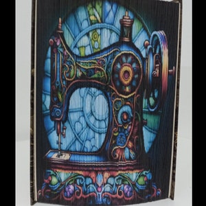 May include: A vintage-style sewing machine with intricate floral details, set against a stained glass window background. The machine is painted in shades of blue, green, and gold.