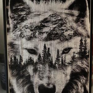 May include: A black and white image of a wolf's face, created using folded paper. The wolf's face is in focus, and the background is blurred. The wolf's fur is made up of many small, folded pieces of paper, creating a textured effect.
