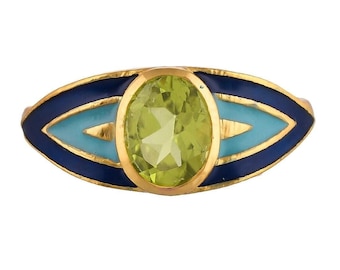 May include: A gold ring with a green oval gemstone set in a blue and light blue enamel eye design.