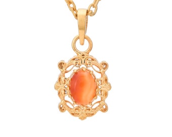 May include: A gold chain necklace with a pendant featuring an oval-shaped orange gemstone set in a filigree design.