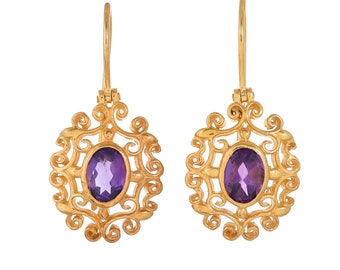 May include: A pair of gold earrings with intricate filigree designs and oval-shaped amethyst gemstones.