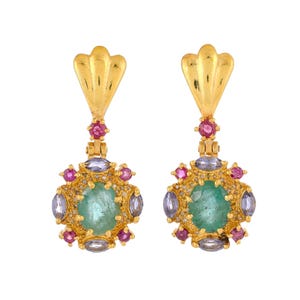 May include: Gold dangle earrings with a green gemstone surrounded by smaller pink and blue gemstones.