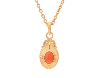 May include: A gold chain necklace with a pendant featuring a coral stone set in a gold filigree frame.