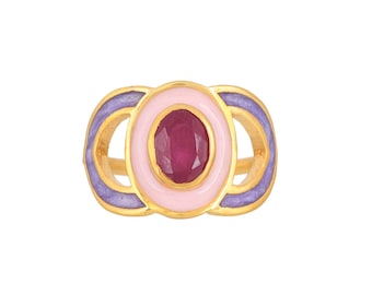 May include: Gold ring with a pink and purple enamel design and a red gemstone in the center.