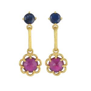 May include: Gold dangle earrings with a pink gemstone surrounded by a gold flower design and a smaller blue gemstone at the top.
