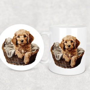 May include: A white ceramic mug with a brown wicker basket and a golden brown puppy inside. The puppy is sitting in the basket with a blanket. The mug has a white handle.