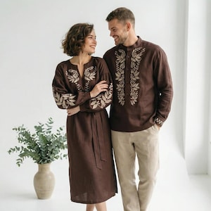 brown dress couple outfit This pre-wedding photoshoot captures the couple in stylish brown outfits, blending beautifully with the natural landscapes of Kerala. The warm earthy tones of their attire enhance the romantic outdoor setting, creating cinematic