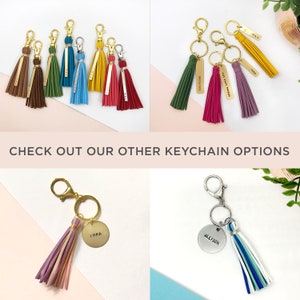 May include: Assortment of colorful tassel keychains with personalized metal tags. Some keychains have names, others have inspirational quotes.  The keychains are displayed on a white background.