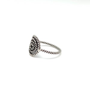 May include: A silver ring with a spiral design on the top. The band is twisted.