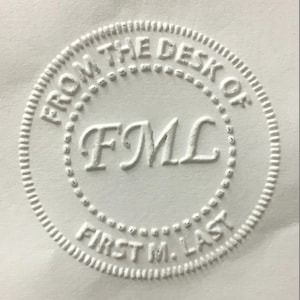 May include: White round seal with the text "From the Desk of FML First M. Last" embossed in a circle.