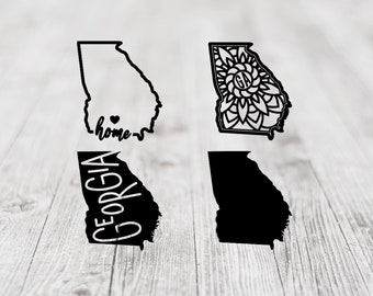 May include: Four black and white designs of the state of Georgia. The first design is a simple outline of the state with the word "home" written inside. The second design is a mandala-style design with the letters "GA" in the center. The third design is a simple outline of the state with the word "Georgia" written inside. The fourth design is a solid black outline of the state.