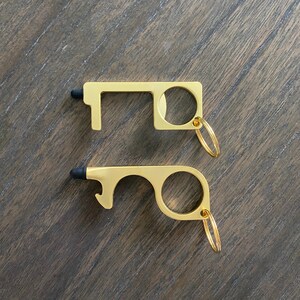 May include: Two gold-colored door openers with a black stylus tip on each end. Both openers have a ring for attaching to a keychain.