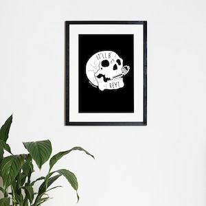 May include: Black and white illustration of a skull with the text "IT'LL B REYT" on a black background.